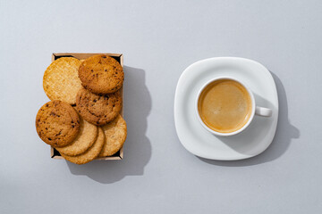 Cookies and cup of coffee on gray background