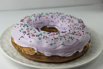 Pumpkin cake decorated with lavender glaze with sugar powder