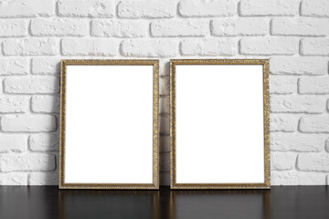 Blank picture frame against brick wall with copy space