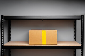 Stand shelf with one packed cardboard box