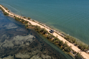 Aerial view of an off-road vehicle on an expedition through a lagoon (Amvrakikos Wetlands National Park)