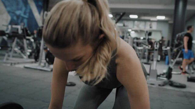 Focus caucasian woman doing deadlift in the gym. Shot with RED helium camera in 8K. 