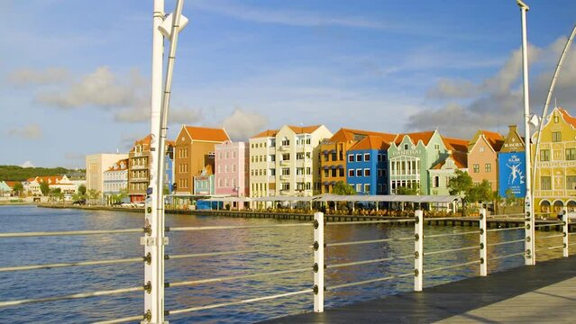 Beautiful, colorful Dutch buildings by the water of Saint Anna Bay in Punda , Willemstad, on the Caribbean island of Curacao. Slow motion push in shot