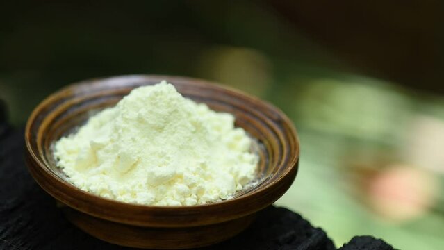 Sulfur or Sulphur powder on nature background.