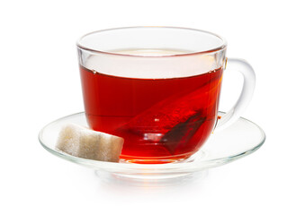 tea bag in a cup isolated on white. with sugar cubes, cherry tone.
