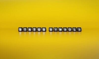 Words ‘Status symbols’ spelled out in white text on dark wooden blocks against plain yellow background. 3D rendering