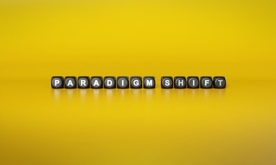 Term ‘Paradigm shift’ spelled out in white text on dark wooden blocks against plain yellow background. 3D rendering - obrazy, fototapety, plakaty