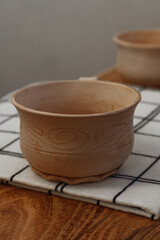 Ceramic cup on a wooden table. Handmade ceramic tableware and pottery
