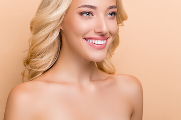 Cropped view portrait of attractive cheerful wavy-haired woman flawless pore harmony isolated over beige pastel color background
