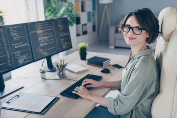 Photo of charming positive hacker female remote working monitoring debugging security problems...