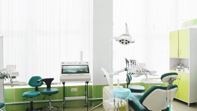 The office of the dental clinic in soothing green colors. Modern equipment and interior. Background for the commercial. Medical footage
