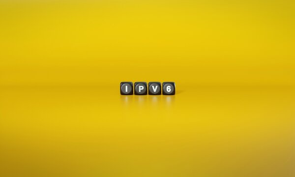 Term ‘IPv6’ Or ‘Internet Protocol Version 6’ Spelled Out In White Text On Dark Wooden Blocks Against Plain Yellow Background. 3D Rendering