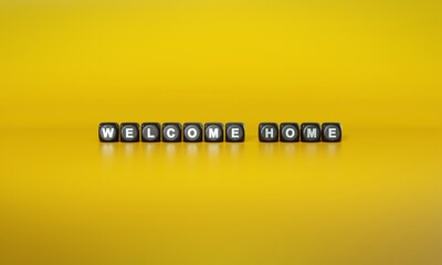 Words ‘Welcome home’ spelled out in white text on dark wooden blocks against plain yellow background. 3D rendering