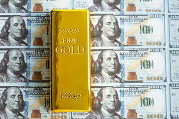 Precious shiny gold bar on dollar bills. gold reserve of the United States of America