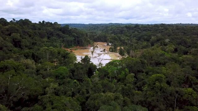 Drone video reveals an illegal gold mining area in the middle of the Amazon rainforest.