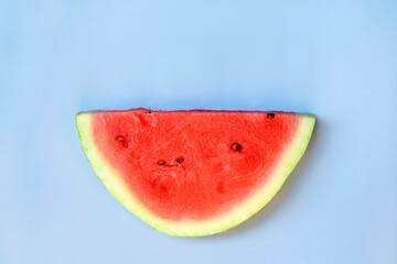 Slice of watermelon on blue background. Summer, summertime, vacation concept.