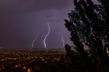 Naklejka na ściany i meble Lightning strikes a multi-story building at night