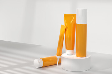 Cosmetics bottles on display podium, mock up banner. Orange tubes of beauty cosmetic skin care products on stage. Sunscreen, eye cream, oil or body lotion on studio background with shadow, 3d render