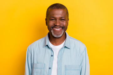 Portrait of satisfied glad candid person beaming smile look camera isolated on yellow color background