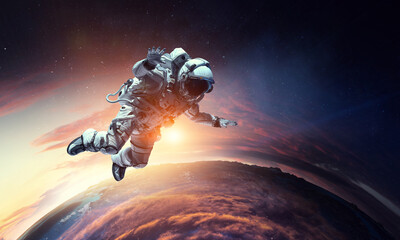Obraz na płótnie Canvas Astronaut at spacewalk . Mixed media