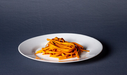 Colorful noodles on a white plate