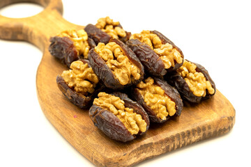 Walnut-stuffed dates isolated on white background. Close-up. Arabian luxury for special occasions such as Ramadan and Eid holidays. local name cevizli hurma