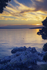 Peaceful scene at the beach of Adriatic sea with beautiful clouds at sunset time. Summer vacation, travel and tourism concepts