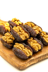 Walnut-stuffed dates isolated on white background. Close-up. Arabian luxury for special occasions such as Ramadan and Eid holidays. local name cevizli hurma