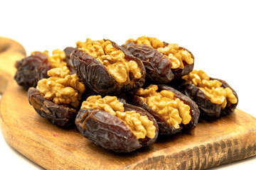 Walnut-stuffed dates isolated on white background. Close-up. Arabian luxury for special occasions such as Ramadan and Eid holidays. local name cevizli hurma
