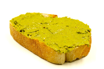 Bread spread with pistachio butter isolated on white background. close up
