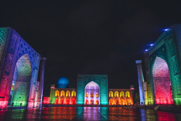Registan square in Samarkand lit in colourful lights, Uzbekistan