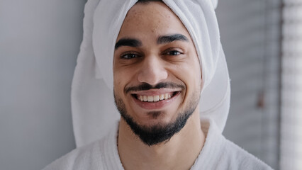 Closeup male face with acne headshot portrait smiling toothy handsome arabian indian bearded man...