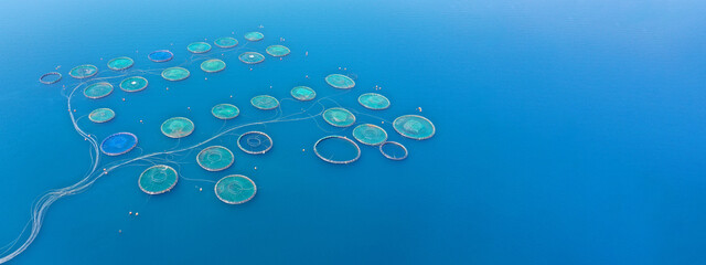 Aerial drone ultra wide panoramic photo with copy space of sea bass and sea bream fishery or fish farming unit in Mediterranean calm deep blue sea