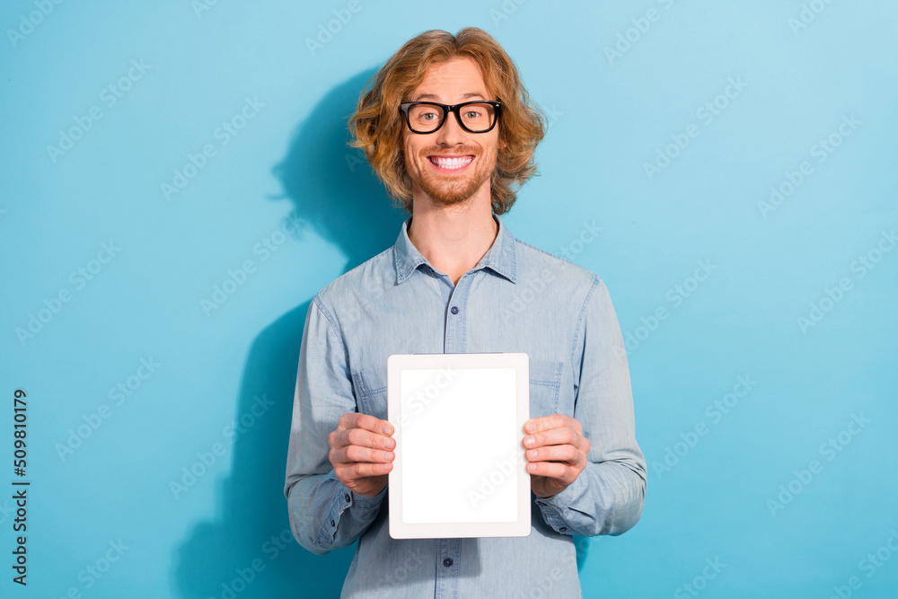 Canvas Prints photo of cheerful person hold demonstrate empty space tablet display isolated on blue color backgrou