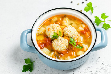 Cosy winter meatball soup in pot. Top view, copy space.