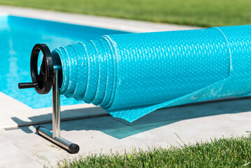 Roll Bubble wrap for the pool. Home pool protection concept. Relax in the backyard of a country house