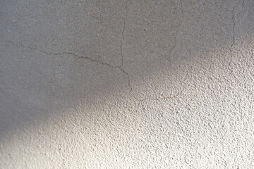 Cement wall texture background with bright light.