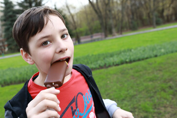 Child eating chocolate ice cream