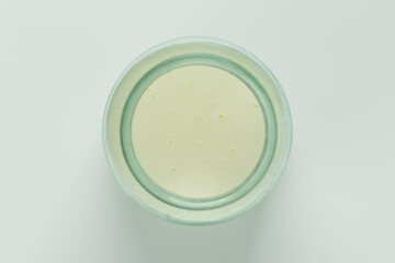 Milk whey in a jar, top view. Homemade traditional drink.