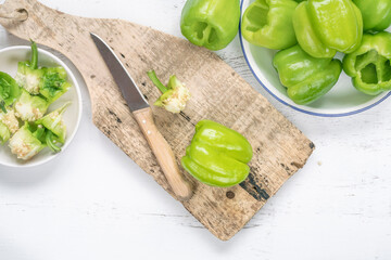 fresh green bell peppers on a cutting board