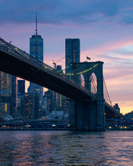 Naklejka na ściany i meble City bridge and city skyline, City bridge at sunset, sunset in New York, Brooklyn bridge at sunset, New York city at twilight, End of the day in NY, Sunrise in New York, Brooklyn bridge panorama view,