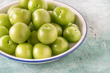 delicious ripe green plum fruits on table
