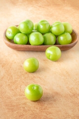 delicious ripe green plum fruits on table
