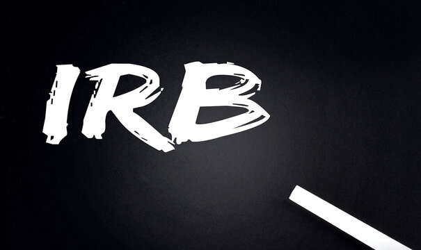 IRB Industrial Revenue Bond text on Black Chalkboard with a piece of chalk