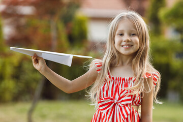little cute girl with paper airplane outdoor - 509815502