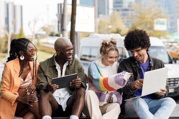 group of people with laptop studying and having fun outdoor