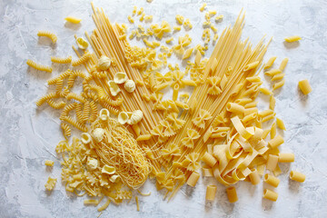 Variety Italian pasta on light background. Top view.