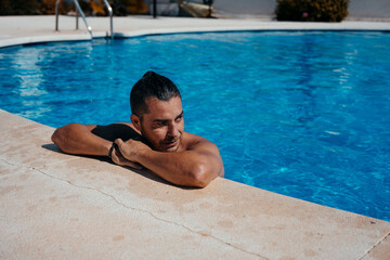 Young man relaxing in swimming pool