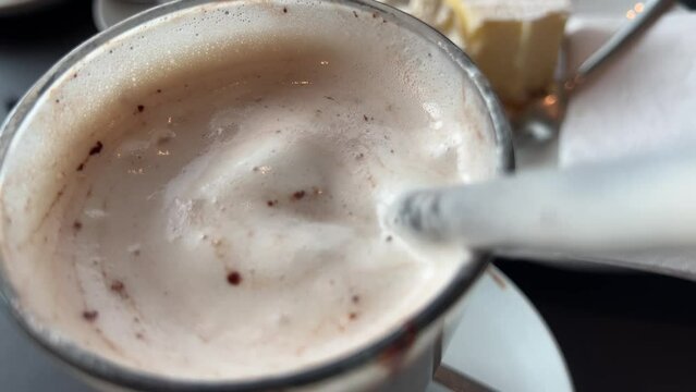 Drinking hot chocolate with cream through a straw