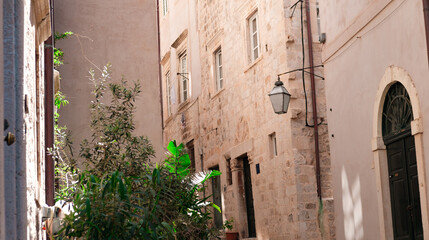Fototapeta na wymiar old town street view, stone buildings, hot summer day, narrow streets